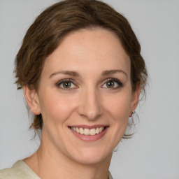 Joyful white young-adult female with medium  brown hair and green eyes