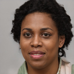 Joyful black young-adult female with long  brown hair and brown eyes