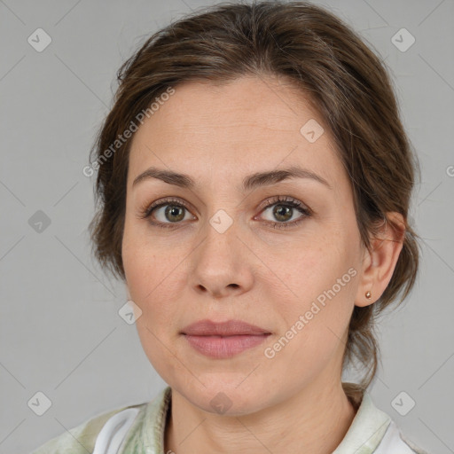 Joyful white adult female with medium  brown hair and green eyes