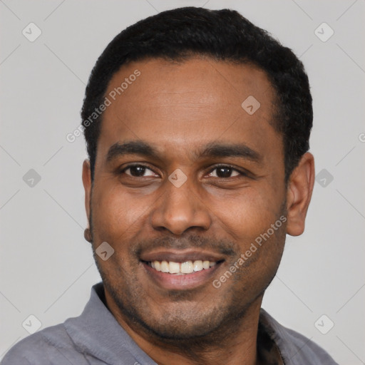 Joyful latino young-adult male with short  black hair and brown eyes