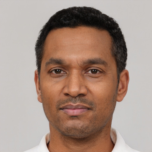 Neutral latino adult male with short  black hair and brown eyes