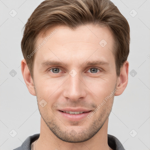 Joyful white young-adult male with short  brown hair and grey eyes