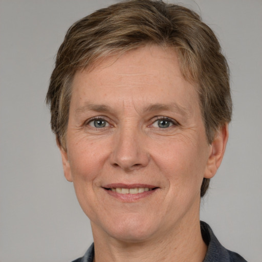 Joyful white adult female with short  brown hair and grey eyes