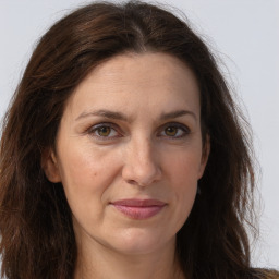 Joyful white adult female with long  brown hair and brown eyes