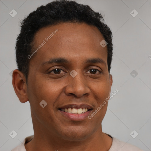 Joyful black young-adult male with short  brown hair and brown eyes