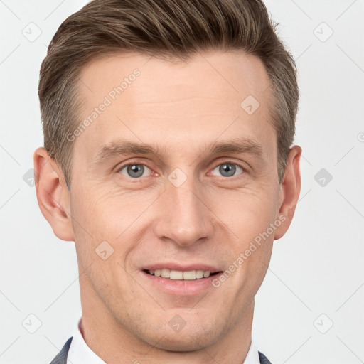 Joyful white young-adult male with short  brown hair and grey eyes