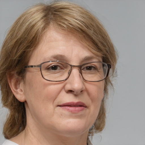 Joyful white middle-aged female with medium  brown hair and blue eyes