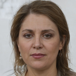 Joyful white adult female with medium  brown hair and grey eyes