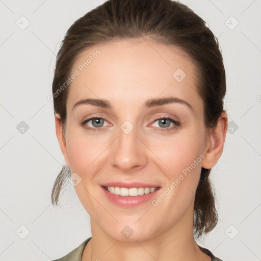 Joyful white young-adult female with medium  brown hair and grey eyes