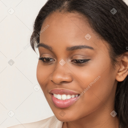 Joyful latino young-adult female with long  brown hair and brown eyes