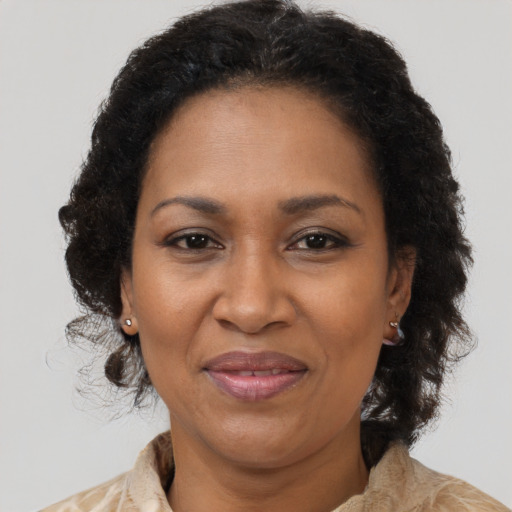 Joyful black adult female with medium  brown hair and brown eyes