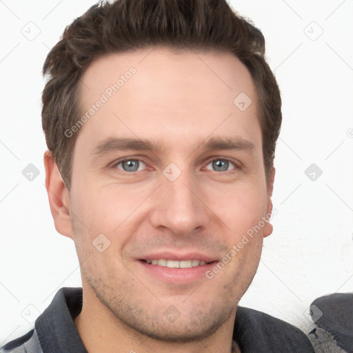 Joyful white young-adult male with short  brown hair and grey eyes