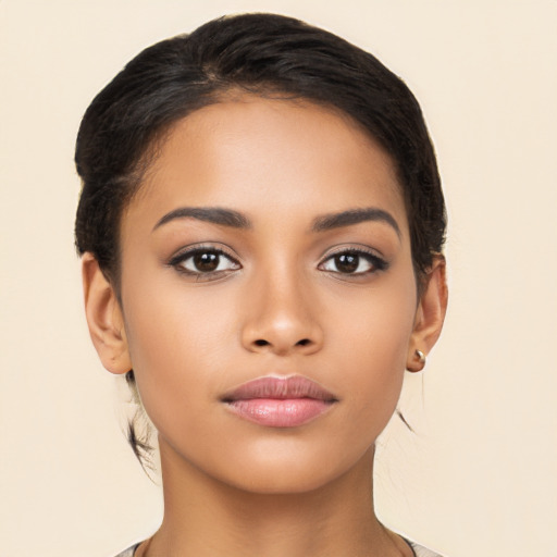 Joyful latino young-adult female with long  brown hair and brown eyes