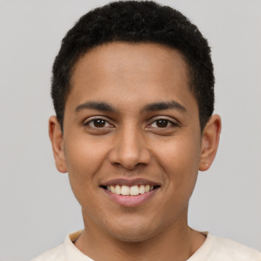 Joyful latino young-adult male with short  brown hair and brown eyes