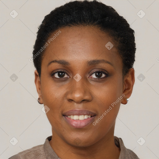 Joyful black young-adult female with short  black hair and brown eyes