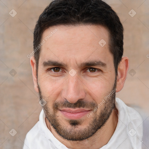 Joyful white adult male with short  black hair and brown eyes