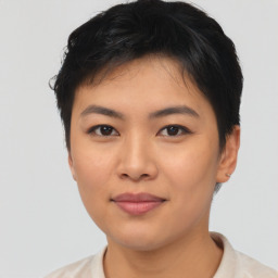 Joyful asian young-adult female with short  black hair and brown eyes