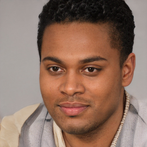 Joyful latino young-adult male with short  brown hair and brown eyes