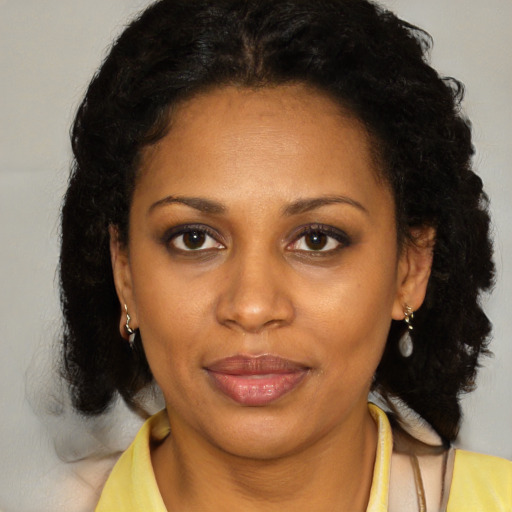 Joyful latino adult female with medium  brown hair and brown eyes