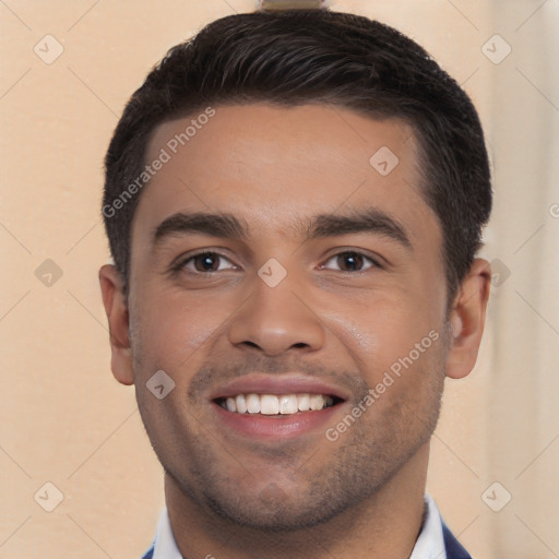 Joyful white young-adult male with short  black hair and brown eyes