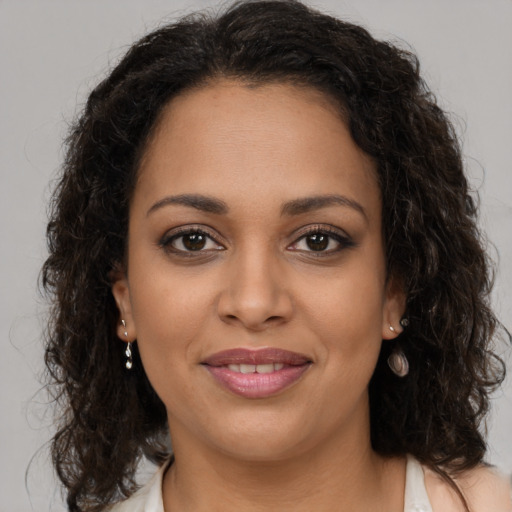 Joyful latino young-adult female with long  brown hair and brown eyes