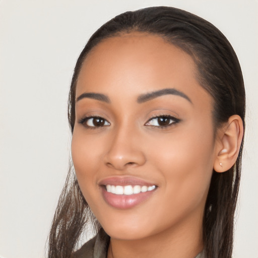 Joyful latino young-adult female with long  black hair and brown eyes