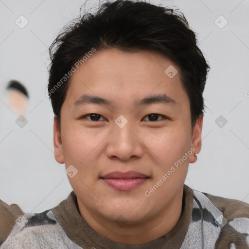 Joyful asian young-adult male with short  brown hair and brown eyes