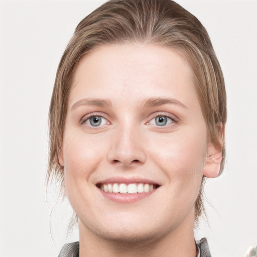 Joyful white young-adult female with medium  brown hair and blue eyes