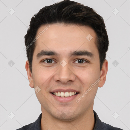 Joyful white young-adult male with short  black hair and brown eyes