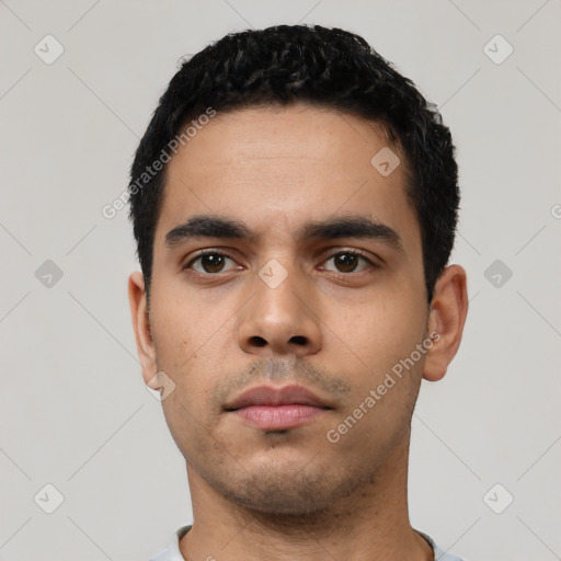 Neutral latino young-adult male with short  black hair and brown eyes