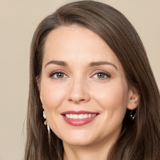 Joyful white young-adult female with long  brown hair and brown eyes