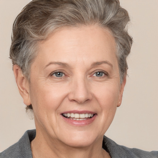 Joyful white adult female with short  brown hair and grey eyes