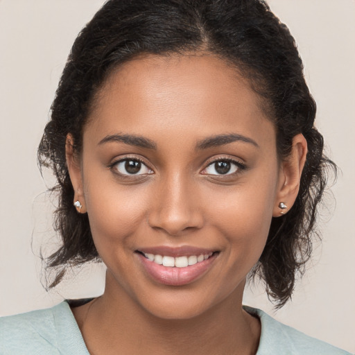 Joyful black young-adult female with medium  brown hair and brown eyes