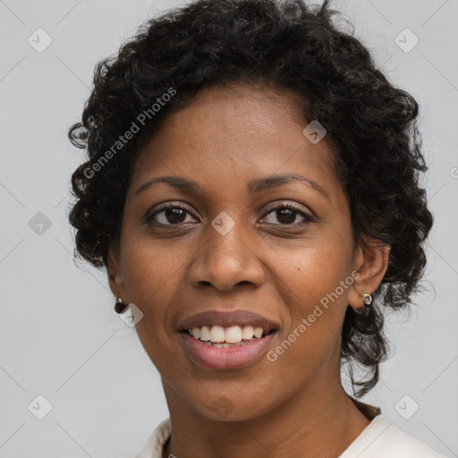 Joyful black young-adult female with long  brown hair and brown eyes