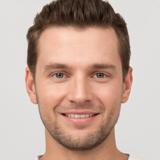 Joyful white young-adult male with short  brown hair and brown eyes