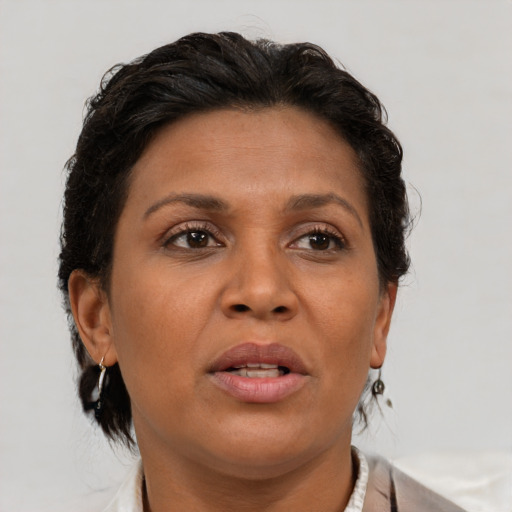 Joyful black adult female with medium  brown hair and brown eyes