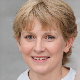 Joyful white young-adult female with medium  brown hair and blue eyes