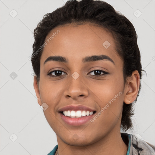 Joyful latino young-adult female with short  brown hair and brown eyes