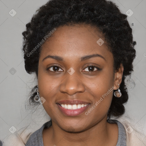 Joyful black young-adult female with long  black hair and brown eyes