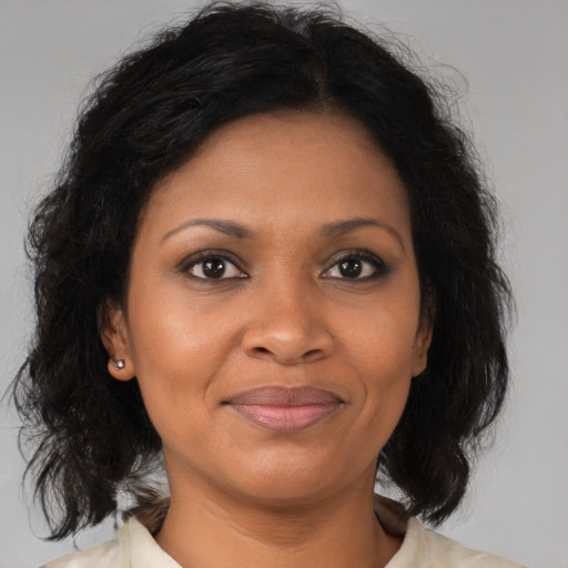 Joyful black adult female with medium  brown hair and brown eyes