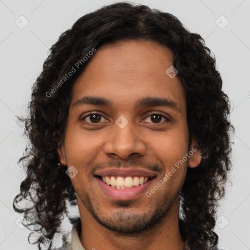 Joyful black young-adult male with short  brown hair and brown eyes