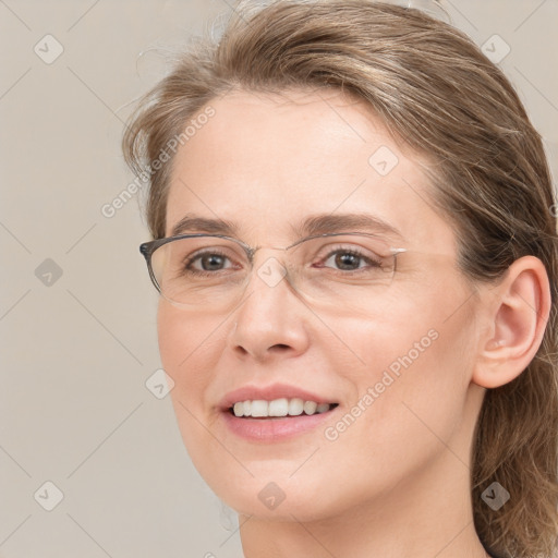 Joyful white adult female with medium  brown hair and grey eyes