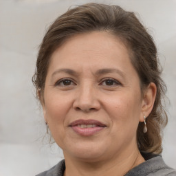 Joyful white adult female with medium  brown hair and brown eyes