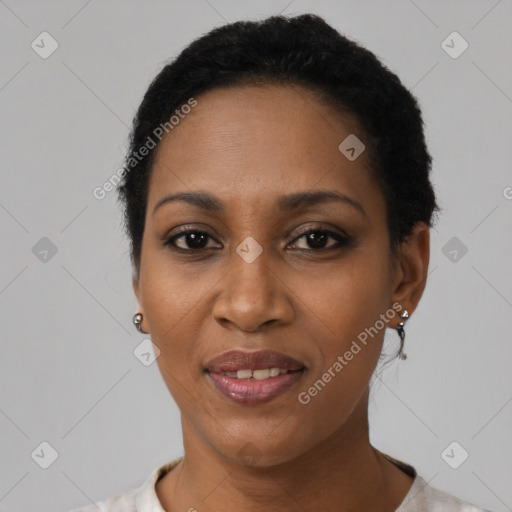 Joyful black young-adult female with short  black hair and brown eyes