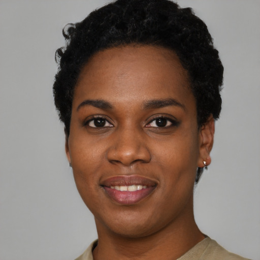 Joyful black young-adult female with short  black hair and brown eyes