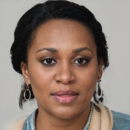 Joyful black adult female with medium  brown hair and brown eyes