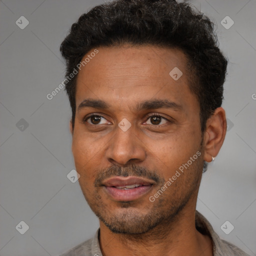 Joyful latino adult male with short  black hair and brown eyes