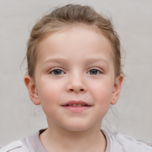 Joyful white child female with short  brown hair and blue eyes