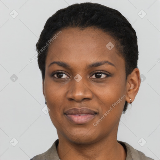 Joyful black young-adult female with short  black hair and brown eyes