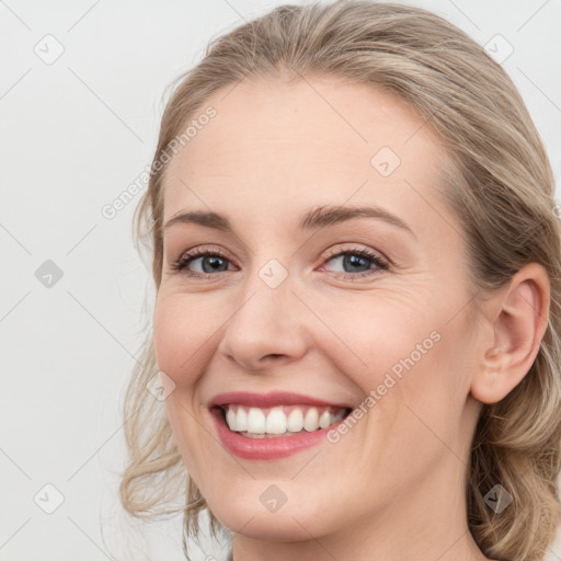 Joyful white young-adult female with medium  brown hair and blue eyes